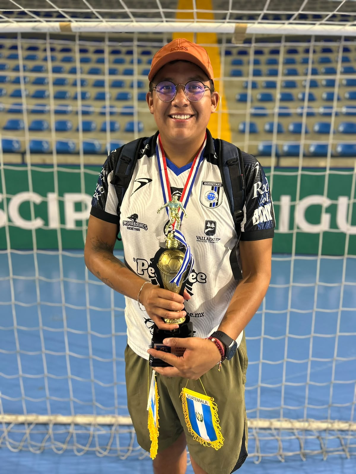 Jugador de Gallos Smiling con el trofeo del Guatemala Futsal Down